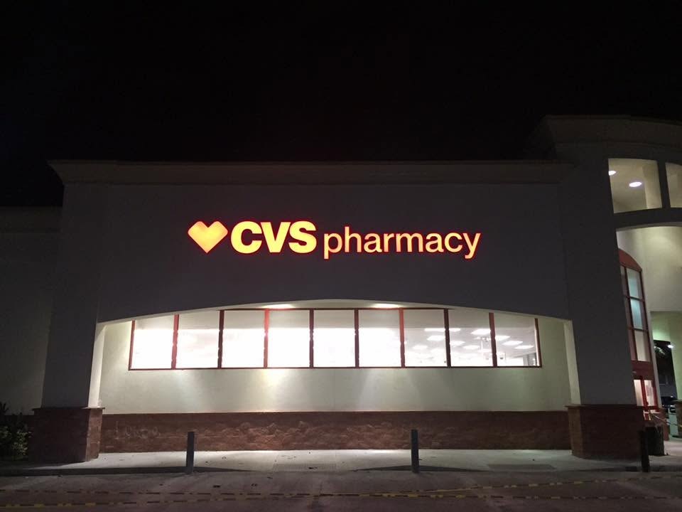 Repaired and fully lit CVS pharmacy channel letter sign glowing at night