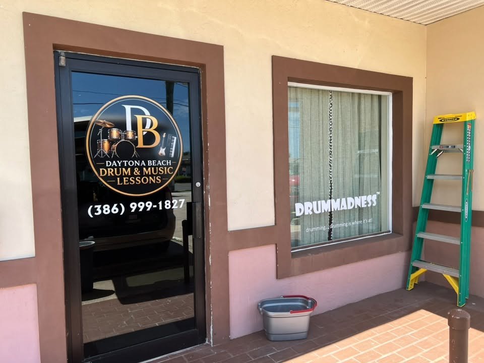 Door vinyl logo and phone number and window lettering for Daytona Beach Drum & Music Lessons